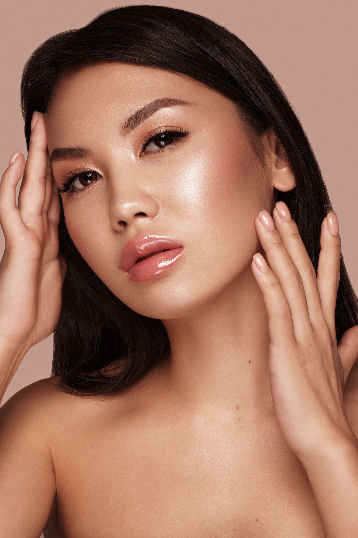 Beautiful delicate woman of oriental type with nude makeup and perfect skin. Beauty face. Spa salon